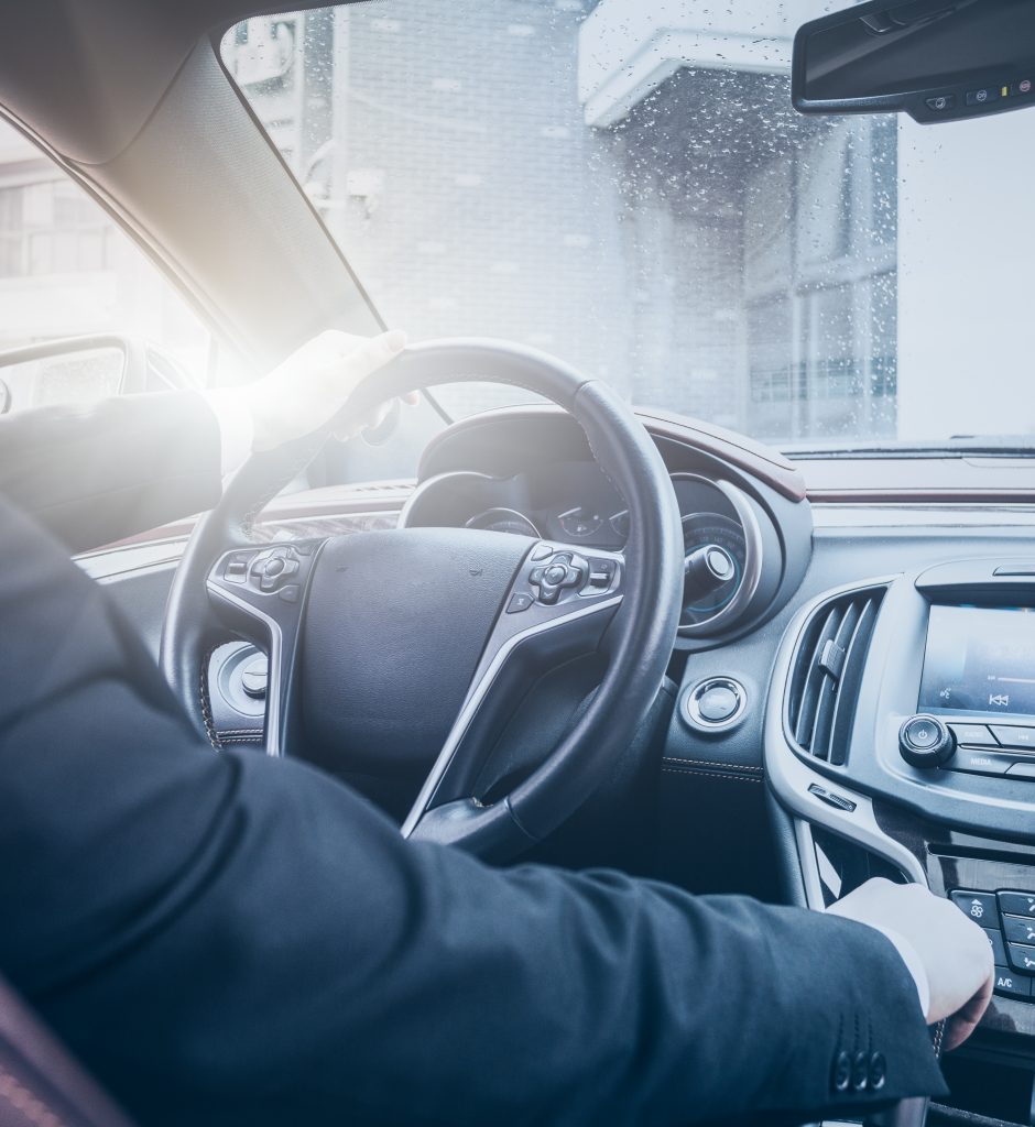 detail shot of young businessman driving his car.